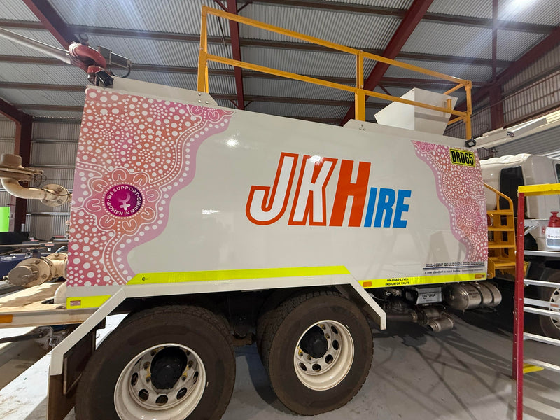 Custom branded JK Hire service truck with Aboriginal artwork, produced by C Signs in Karratha for a Pilbara business.