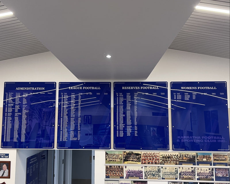 Custom blue honour boards for Karratha Kats Football League mounted on an interior wall installed in Karratha by C Signs