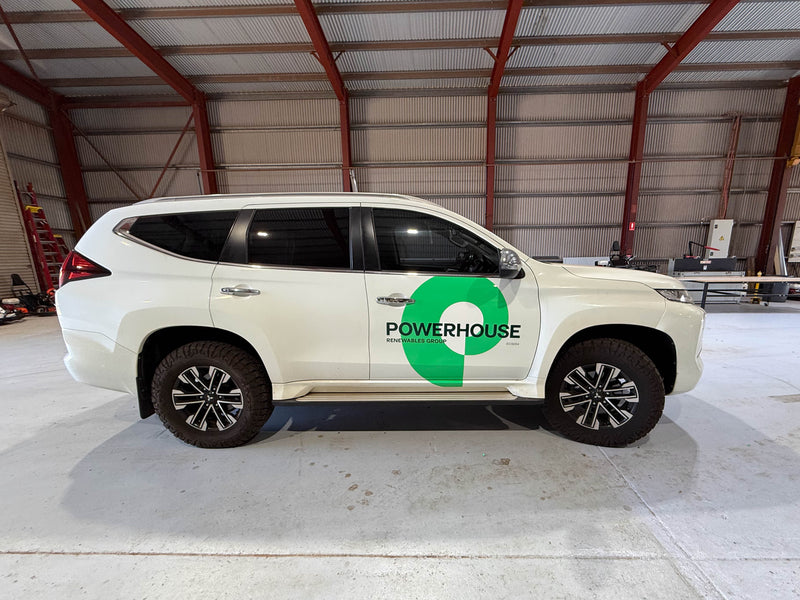 White SUV with Powerhouse Energy vehicle branding installed in Karratha by C Signs Pilbara