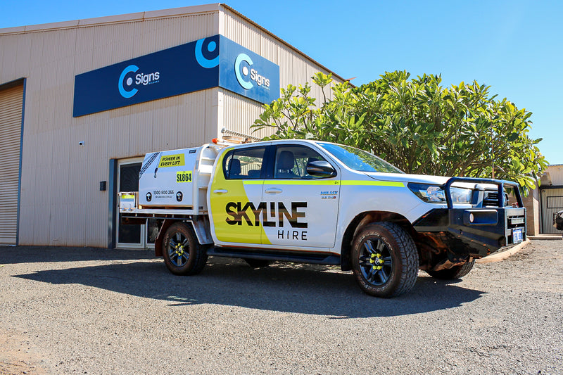 Skyline Hire Toyota Hilux service vehicle with custom printed and cut vinyl graphics, photographed outside the C Signs workshop in Karratha.