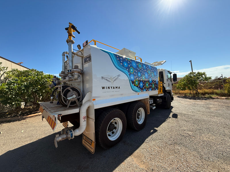 Winyama Contracting Group white water truck with blue and green Aboriginal art design wrap installed in Karratha by C Signs Pilbara